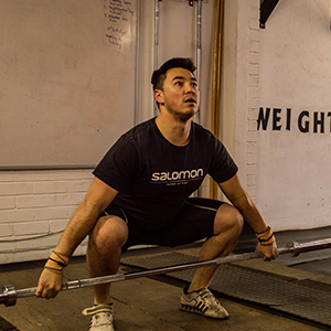 man standing with barbell on the floor position